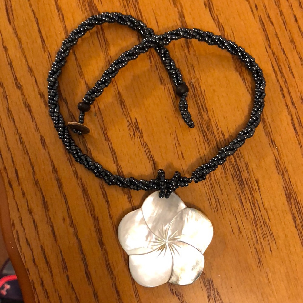 Beaded necklace with flower pendant.
